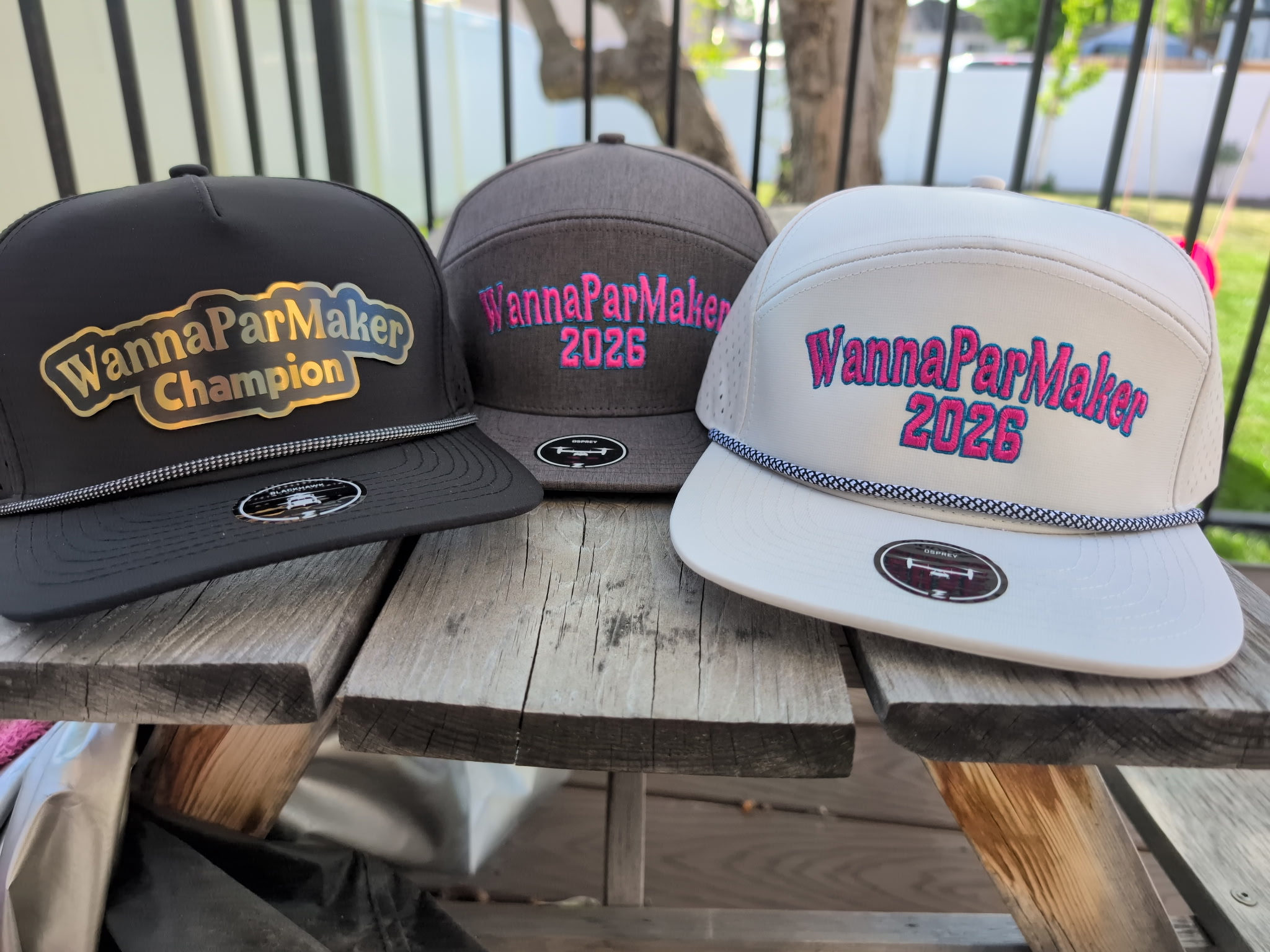 The 2026 lids have landed. Champion black, participant grey, participant white.